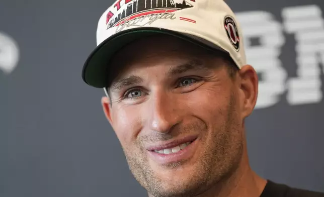 Atlanta Falcons quarterback Kirk Cousins speaks to the media after an NFL training camp football practice Thursday, July 25, 2024, in Flowery Branch, Ga. (AP Photo/John Bazemore)