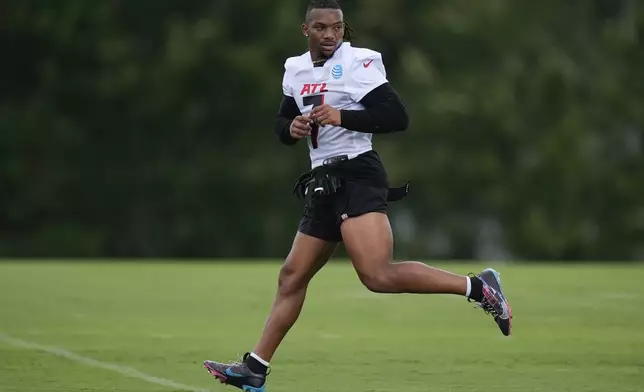 Atlanta Falcons running back Bijan Robinson runs a drill during an NFL training camp football practice Thursday, July 25, 2024, in Flowery Branch, Ga. (AP Photo/John Bazemore)