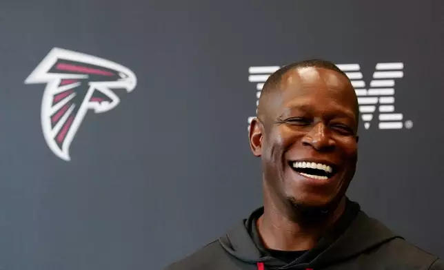 Atlanta Falcons head coach Raheem Morris speaks to the media before the team's first NFL training camp football practice Thursday, July 25, 2024, in Flowery Branch, Ga. (AP Photo/John Bazemore)