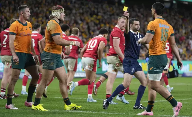 Referee Pierre Brousset shows a yellow card Australia's Fraser McReight, second left, during the rugby international between Australia and Wales in Sydney, Australia, Saturday, July 6, 2024. (AP Photo/Rick Rycroft)