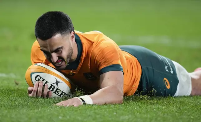 Australia's Tom Wright scores a try during the rugby international between Australia and Wales in Sydney, Australia, Saturday, July 6, 2024. (AP Photo/Rick Rycroft)