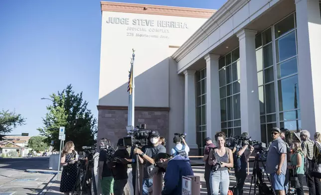 Media members gather outside District Court as they await the arrival of Actor Alec Baldwin, for jury selection in his involuntary manslaughter trial, Wednesday, July 10, 2024, in Santa Fe, N.M. (AP Photo/Roberto E. Rosales)