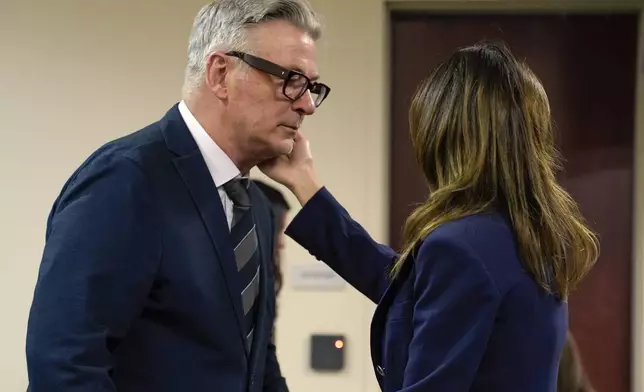 Actor Alec Baldwin approaches his wife Hilaria during his trial, Thursday, July 11, 2024, in Santa Fe, N.M. Baldwin is charged with involuntary manslaughter in the 2021 fatal shooting of cinematographer Halyna Hutchins during filming of the Western movie "Rust". (Ramsay de Give/Pool Photo via AP)