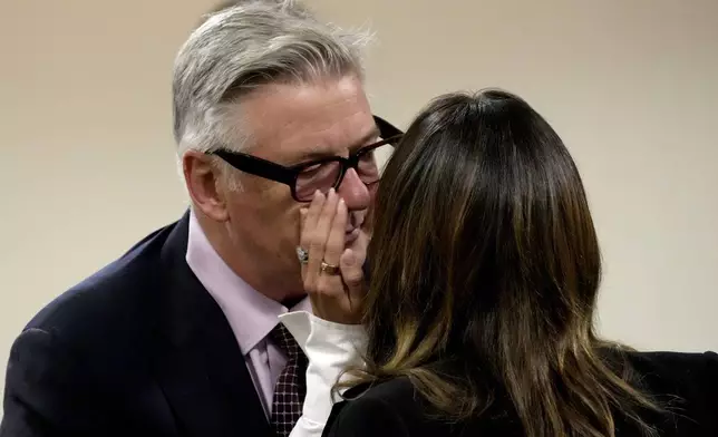 Actor Alec Baldwin interacts with wife Hilaria Baldwin during a break in his hearing in Santa Fe County District Court, Wednesday, July 10, 2024, in Santa Fe, N.M. Baldwin is facing a single charge of involuntary manslaughter in the death of a cinematographer. (AP Photo/Ross D. Franklin, Pool)