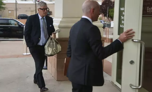 Actor Alec Baldwin, left, and his arrives at the courthouse for a pretrial hearing Monday, July 8, 2024, in Santa Fe, N.M. The actor's involuntary manslaughter trial starts July 9 with jury selection. (Luis Sánchez Saturno/Santa Fe New Mexican via AP)