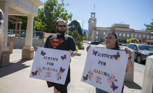 Jonathan Zwiebel, left, and his mother Janelle Rogers stand outside District Court demanding justice for cinematographer Halyna Hutchins, during the trial of actor Alec Baldwin, Wednesday, July 10, 2024, in Santa Fe, N.M. (AP Photo/Roberto E. Rosales)