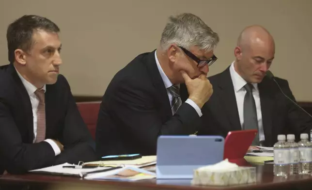 Actor Alec Baldwin, center, and his attorneys Alex Spiro, left, and Luke Nikas appear for a pretrial hearing Monday, July 8, 2024, in Santa Fe, N.M. The actor's involuntary manslaughter trial starts July 9 with jury selection. (Luis Sánchez Saturno/Santa Fe New Mexican via AP)