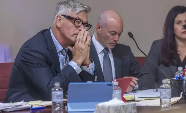 Actor Alec Baldwin, left, sits with his lawyers Luke Nikas, second right, and Heather LeBlanc in District Court in Santa Fe, N.M., during a preliminary hearing for the "Rust" trial on Monday, July 8, 2024. Baldwin faces a single charge of involuntary manslaughter in the death of a cinematographer on the set of the film, "Rust." (Luis Sánchez Saturno/Santa Fe New Mexican via AP)