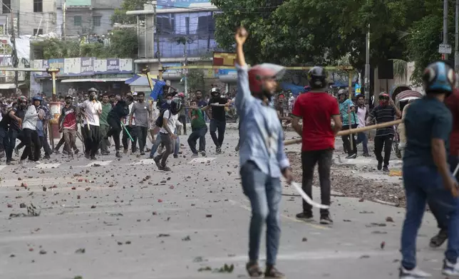 Students clash over quota system at Jahangir Nagar University at Savar outside Dhaka, Bangladesh, Monday, July 15, 2024. Police have fired tear gas and charged with batons overnight during violent clashes between a pro-government student body and student protesters, leaving dozens injured at a leading public university outside Bangladesh's capital over quota system in government jobs, police and students said Tuesday.(AP Photo/Abdul Goni)