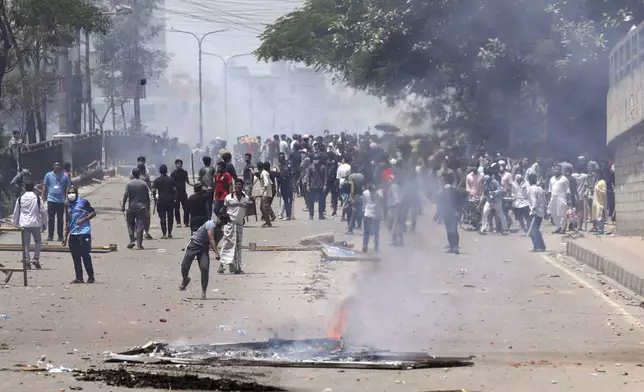 Students clash with riot police during a protest against a quota system for government jobs, in Dhaka, Bangladesh, Thursday, July 18, 2024. (AP Photo/Rajib Dhar)