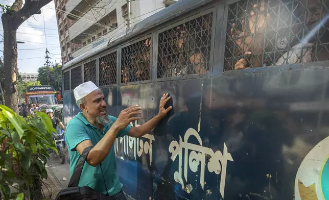 Robiul Bashar is anguished as both of his twin sons were arrested and are transported in a police van in Dhaka, Bangladesh, Thursday, July 25, 2024. Media reports say that several people have been arrested in recent days across the country after more than a week of chaos triggered by student protests over a quota system in government jobs. (AP Photo/Rajib Dhar)