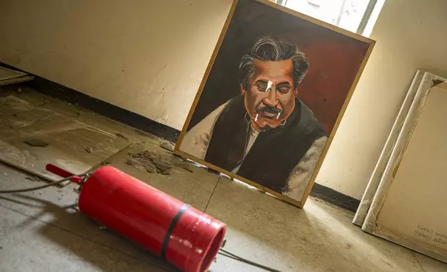 A painted portrait of Sheikh Mujibur Rahman, founding father of Bangladesh, lies on the floor of a damaged studio of the state-owned Bangladesh Television (BTV) in Dhaka, Bangladesh, Wednesday, July 24, 2024. (AP Photo/Rajib Dhar)