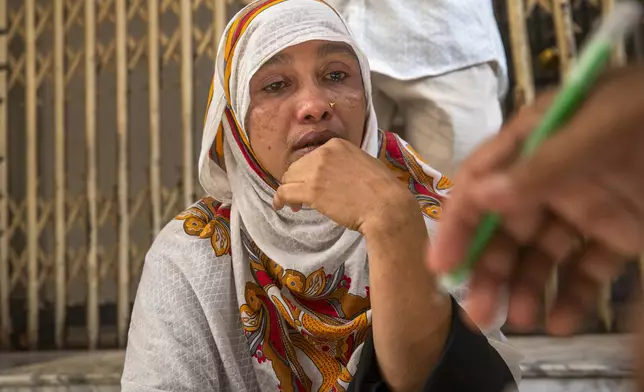 Fatema grieves outside a court after her husband, a rickshaw driver, was arrested on Wednesday from their home in Dhaka, Bangladesh, Thursday, July 25, 2024. Media reports say that several people have been arrested in recent days across the country after more than a week of chaos triggered by student protests over a quota system in government jobs. (AP Photo/Rajib Dhar)