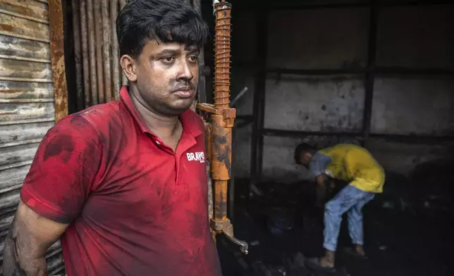 Nizam Uddin has tears in his eyes as he stands in front of his burnt shop which was set on fire during a clash two days ago which turned into vandalism along the Dhaka Chittagong highway in Dhaka, Bangladesh, Tuesday, July 23, 2024. Internet and mobile data services are still down despite apparent calm in Bangladesh following a verdict that scaled back a controversial quota system for government jobs after weeks of relentless protests that turned deadly. (AP Photo/Rajib Dhar)