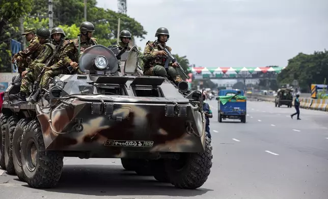 Bangladeshi army patrols in an armored vehicle the Dhaka-Chittagong highway on the fourth day of curfew imposed by the government amidst the countrywide deadly clashes, in Dhaka, Bangladesh, Tuesday, July 23, 2024. Internet and mobile data services are still down despite apparent calm in Bangladesh following a verdict that scaled back a controversial quota system for government jobs after weeks of relentless protests that turned deadly. (AP Photo/Rajib Dhar)