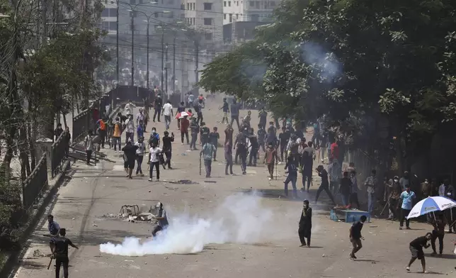 Students clash with riot police during a protest against a quota system for government jobs, in Dhaka, Bangladesh, Thursday, July 18, 2024. (AP Photo/Rajib Dhar)