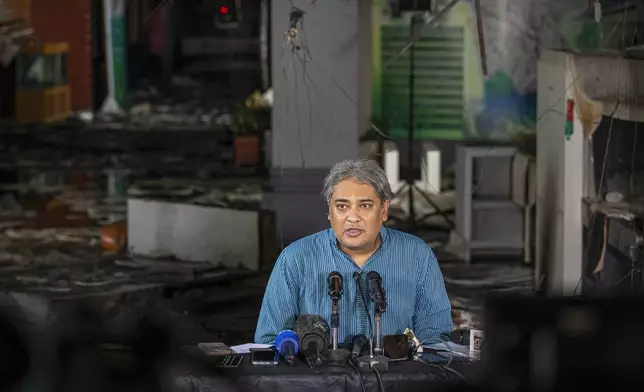 Bangladesh Minister of State for Information and Broadcasting, Mohammad A. Arafat, talks to reporters inside a burnt studio of the state-owned Bangladesh Television (BTV) in Dhaka, Bangladesh, Wednesday, July 24, 2024. (AP Photo/Rajib Dhar)