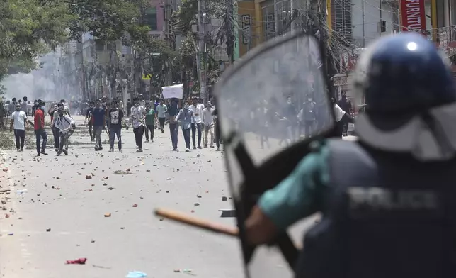 Students clash with riot police during a protest against a quota system for government jobs, in Dhaka, Bangladesh, Thursday, July 18, 2024. (AP Photo/Rajib Dhar)