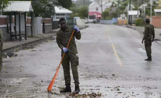 Members of the Barbados Defence Force clean up a street after Hurricane Beryl passed through Oistins, Barbados, Monday, July 1, 2024. (AP Photo/Ricardo Mazalan)