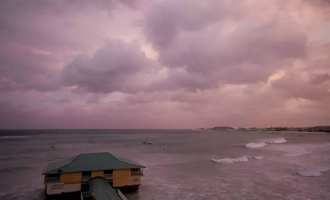 Day breaks over a pier as Hurricane Beryl passes through Bridgetown, Barbados, Monday, July 1, 2024. (AP Photo/Ricardo Mazalan)