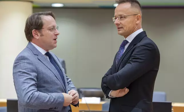 Hungary's Foreign Minister Peter Szijjarto, right, talks with European Commissioner for Neighbourhood and Enlargement Oliver Varhelyi during a meeting of EU foreign ministers at the European Council building in Brussels, Monday, July 22, 2024. European Union foreign ministers on Monday meet to discuss Russian aggression against Ukraine and the situation in the Middle East. (AP Photo/Geert Vanden Wijngaert)