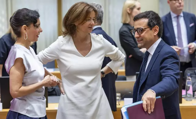 French Foreign Minister Stephane Sejourne, right talks with Belgium's Foreign Minister Hadja Lahbib, left, and Slovenia's Foreign Minister Tanja Fajon, center, during a meeting of EU foreign ministers at the European Council building in Brussels, Monday, July 22, 2024. European Union foreign ministers on Monday meet to discuss Russian aggression against Ukraine and the situation in the Middle East. (AP Photo/Geert Vanden Wijngaert)