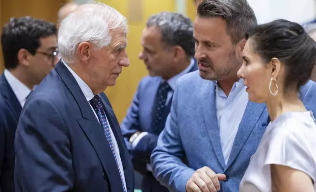 European Union foreign policy chief Josep Borrell, left, talks with Luxembourg's Foreign Minister Xavier Bettel, center, and Belgium's Foreign Minister Hadja Lahbib, right, during a meeting of EU foreign ministers at the European Council building in Brussels, Monday, July 22, 2024. European Union foreign ministers on Monday meet to discuss Russian aggression against Ukraine and the situation in the Middle East. (AP Photo/Geert Vanden Wijngaert)