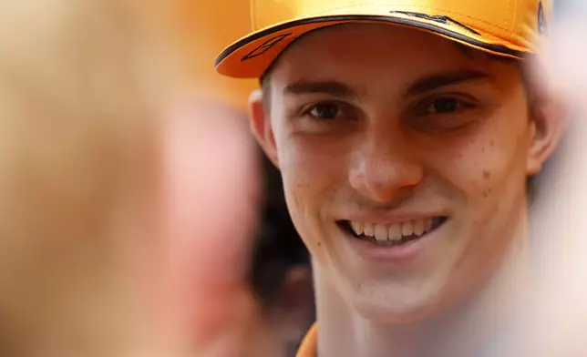 McLaren driver Oscar Piastri of Australia speaks with the media as he arrives in the paddock ahead of the Formula One Grand Prix at the Spa-Francorchamps racetrack in Spa, Belgium, Thursday, July 25, 2024. The Belgian Formula One Grand Prix will take place on Sunday. (AP Photo/Geert Vanden Wijngaert)