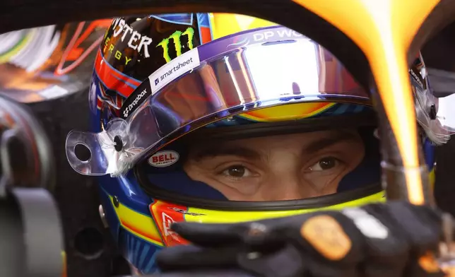 McLaren driver Oscar Piastri of Australia sits in his car inside the team garage prior to the second practice session ahead of the Formula One Grand Prix at the Spa-Francorchamps racetrack in Spa, Belgium, Friday, July 26, 2024. The Belgian Formula One Grand Prix will take place on Sunday. (AP Photo/Geert Vanden Wijngaert)