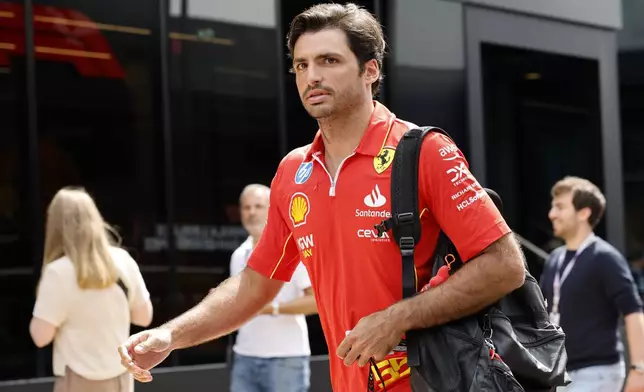 Ferrari driver Carlos Sainz of Spain arrives in the paddock ahead of the Formula One Grand Prix at the Spa-Francorchamps racetrack in Spa, Belgium, Thursday, July 25, 2024. The Belgian Formula One Grand Prix will take place on Sunday. (AP Photo/Geert Vanden Wijngaert)