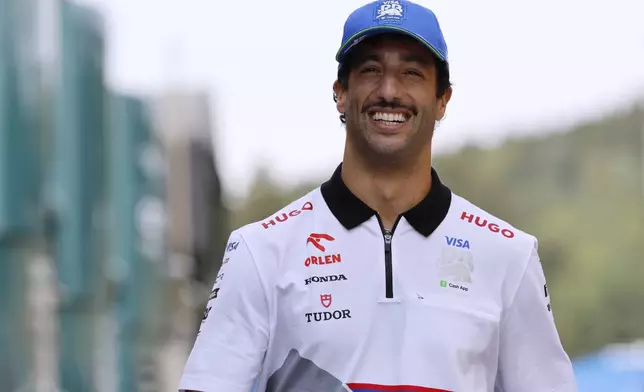 RB driver Daniel Ricciardo of Australia arrives in the paddock ahead of the Formula One Grand Prix at the Spa-Francorchamps racetrack in Spa, Belgium, Thursday, July 25, 2024. The Belgian Formula One Grand Prix will take place on Sunday. (AP Photo/Geert Vanden Wijngaert)