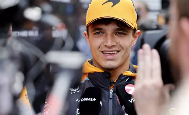 McLaren driver Lando Norris of Britain speaks with the media as he arrives in the paddock ahead of the Formula One Grand Prix at the Spa-Francorchamps racetrack in Spa, Belgium, Thursday, July 25, 2024. The Belgian Formula One Grand Prix will take place on Sunday. (AP Photo/Geert Vanden Wijngaert)