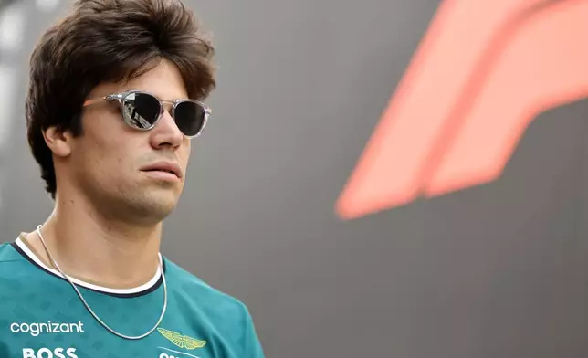 Aston Martin driver Lance Stroll of Canada arrives in the paddock ahead of the Formula One Grand Prix at the Spa-Francorchamps racetrack in Spa, Belgium, Thursday, July 25, 2024. The Belgian Formula One Grand Prix will take place on Sunday. (AP Photo/Geert Vanden Wijngaert)