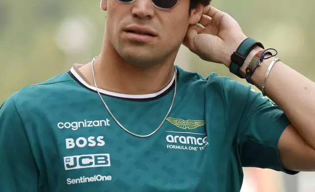 Aston Martin driver Lance Stroll of Canada arrives in the paddock ahead of the Formula One Grand Prix at the Spa-Francorchamps racetrack in Spa, Belgium, Thursday, July 25, 2024. The Belgian Formula One Grand Prix will take place on Sunday. (AP Photo/Geert Vanden Wijngaert)