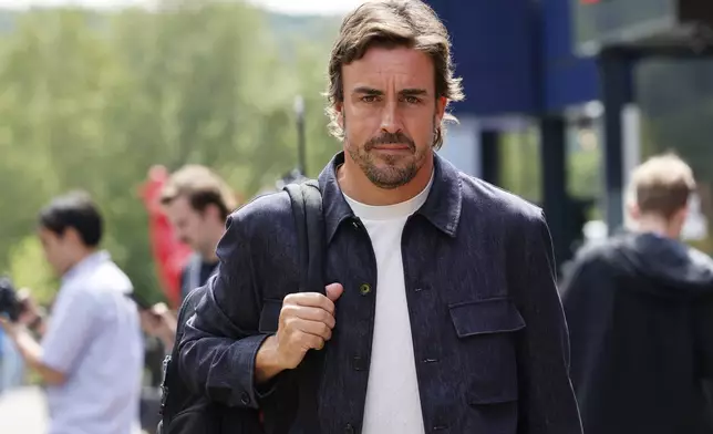 Aston Martin driver Fernando Alonso of Spain arrives in the paddock ahead of the Formula One Grand Prix at the Spa-Francorchamps racetrack in Spa, Belgium, Thursday, July 25, 2024. The Belgian Formula One Grand Prix will take place on Sunday. (AP Photo/Geert Vanden Wijngaert)