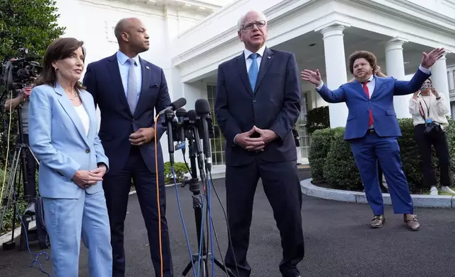 Fagan Harris, far right, chief of staff to Maryland Gov. Moore, gestures for governors to finish answering questions from reporters, as from left, New York Gov. Kathy Hochul, Maryland Gov. Wes Moore and Minnesota Gov. Tim Walz listen after they met with President Joe Biden, Wednesday, July 3, 2024, at the White House in Washington. (AP Photo/Susan Walsh)