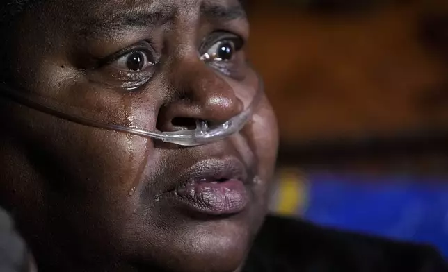 Shelia Mae Dobbins cries as she talks about her health inside her home in Gloster, Miss., Wednesday, May 29, 2024. Dobbins feels her life — and health — were better before Drax began compressing tons of wood chips nearby. (AP Photo/Gerald Herbert)