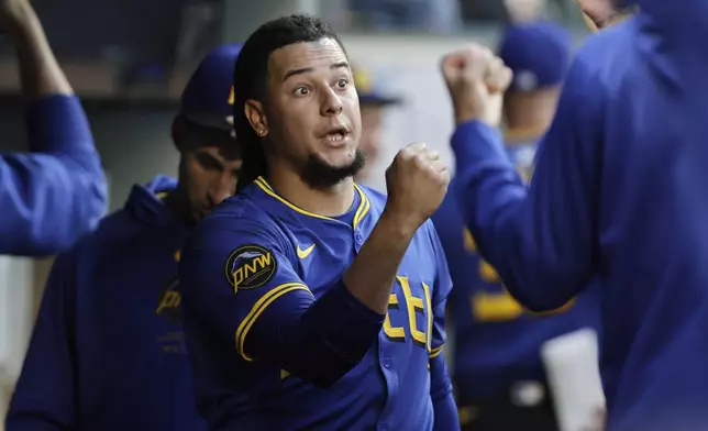 Seattle Mariners starting pitcher Luis Castillo is greeted in the dugout after leaving during the seventh inning against the Toronto Blue Jays in a baseball game Friday, July 5, 2024, in Seattle. (AP Photo/John Froschauer)