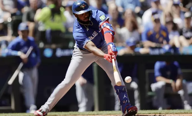 Toronto Blue Jays' Vladimir Guerrero Jr. hits an RBI single against the Seattle Mariners during the fifth inning in a baseball game, Saturday, July 6, 2024, in Seattle. (AP Photo/John Froschauer)