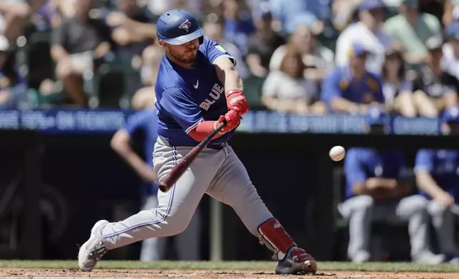 Toronto Blue Jays' Alejandro Kirk hits an RBI double against the Seattle Mariners during the fourth inning in a baseball game, Saturday, July 6, 2024, in Seattle. (AP Photo/John Froschauer)