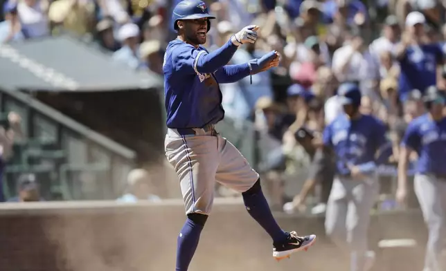 Toronto Blue Jays' George Springer reacts after scoring against the Seattle Mariners during the fifth inning in a baseball game, Saturday, July 6, 2024, in Seattle. (AP Photo/John Froschauer)