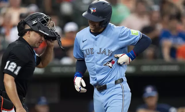 Toronto Blue Jays' Ernie Clement reacts after being hit by a pitch delivered by Baltimore Orioles starting pitcher Corbin Burnes during the fourth inning of a baseball game Tuesday, July 30, 2024, in Baltimore. (AP Photo/Stephanie Scarbrough)