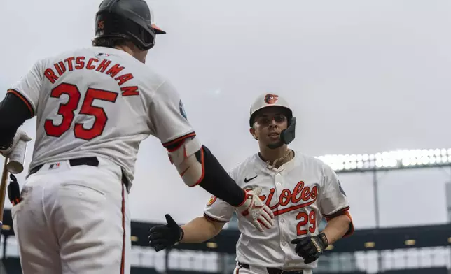 Baltimore Orioles' Ramon Urias (29) celebrates hitting a home run with Adley Rutschman (35) during the third inning of a baseball game against the Toronto Blue Jays, Tuesday, July 30, 2024, in Baltimore. (AP Photo/Stephanie Scarbrough)