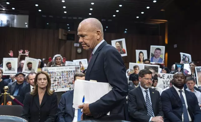 FILE - With protesters in the audience, Boeing CEO Dave Calhoun arrives at a Senate subcommittee hearing to answer to lawmakers about troubles at the aircraft manufacturer. Ike Riffel , a California father whose two sons, died in 2019 when a Boeing 737 Max jetliner crashed in Ethiopia, fears that instead of putting Boeing on trial, the government will offer the company another shot at corporate probation through a legal document called a deferred prosecution agreement, or DPA. (AP Photo/J. Scott Applewhite, File)