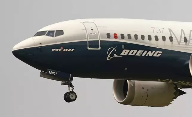 FILE - A Boeing 737 Max jet, piloted by Federal Aviation Administration (FAA) chief Steve Dickson, prepares to land at Boeing Field following a test flight on Sept. 30, 2020 in Seattle. On Sunday, July 7, 2024, the Justice Department said Boeing has agreed to plead guilty to a criminal fraud charge stemming from two deadly crashes of 737 Max jetliners. (AP Photo/Elaine Thompson, File)