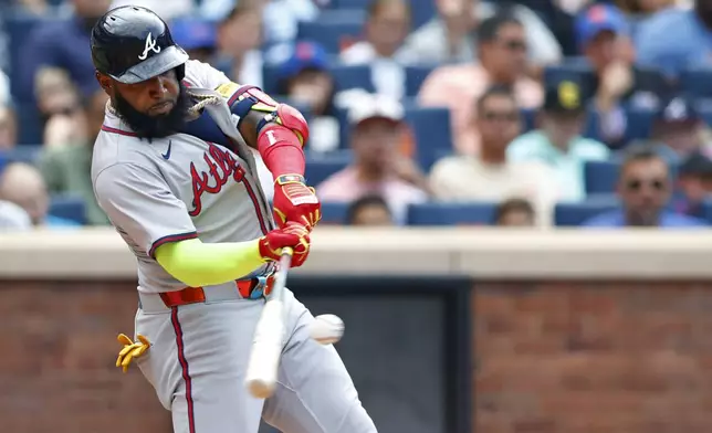 Atlanta Braves designated hitter Marcell Ozuna hits a home run against the New York Mets during the fourth inning of a baseball game, Saturday, July 27, 2024, in New York. (AP Photo/Rich Schultz)