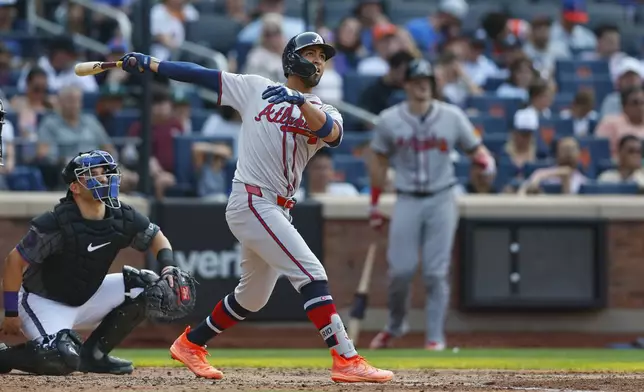 Atlanta Braves outfielder Eddie Rosario (8) hits a home run during the seventh inning of a baseball game against the New York Mets, Saturday, July 27, 2024, in New York. (AP Photo/Rich Schultz)