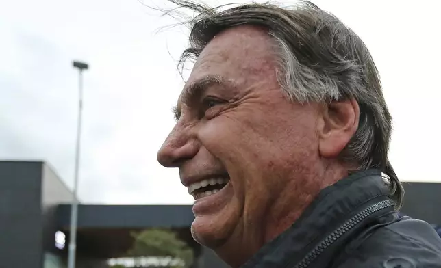 Brazilian former President Jair Bolsonaro deplanes at the international airport in Florianopolis, Santa Catarina state, Brazil, Friday, July 5, 2024. Brazilian police have indicted Bolsonaro for money laundering and criminal association in connection with undeclared diamonds the far-right leader received from Saudi Arabia during his time in office, according to a source with knowledge of the accusations. (AP Photo/Heuler Andrey)