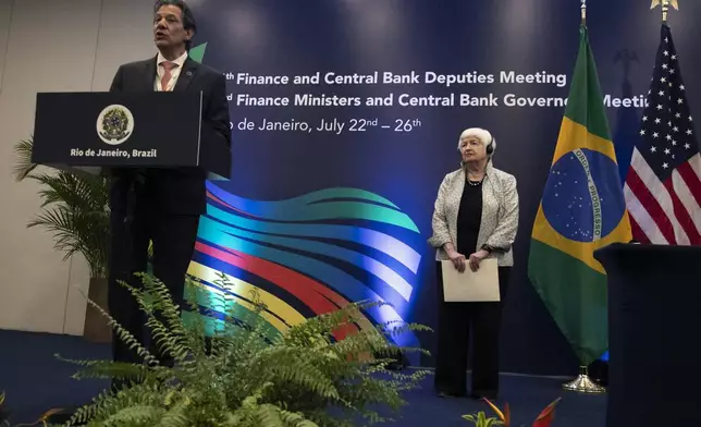 Brazilian Economy Minister Fernando Haddad, left, speaks after signing a joint statement with U.S. Treasury Secretary Janet L. Yellen, right, on the Climate Partnership, between Brazil's Ministry of Finance and the U.S. Department of the Treasury, during a G20 economic ministers' meeting in Rio de Janeiro, Brazil, Friday, July 26, 2024. (AP Photo/Bruna Prado)