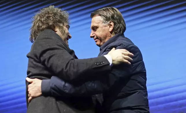 Argentina's President Javier Milei, left, hugs Brazilian former President Jair Bolsonaro during CPAC Brasil 2024, a conservative event, in Balneario Camboriu, Santa Catarina state, Brazil, Sunday, July 7, 2024. (AP Photo/Heuler Andrey)